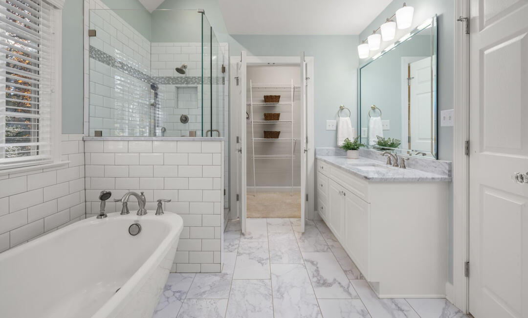 Bathroom Renovation Packages Sydney, Freestanding Bathtub & Modern Design Contemporary bathroom remodel in Sydney with a freestanding bathtub, glass shower enclosure, marble-look flooring, subway tiles, and custom bathroom renovation services.